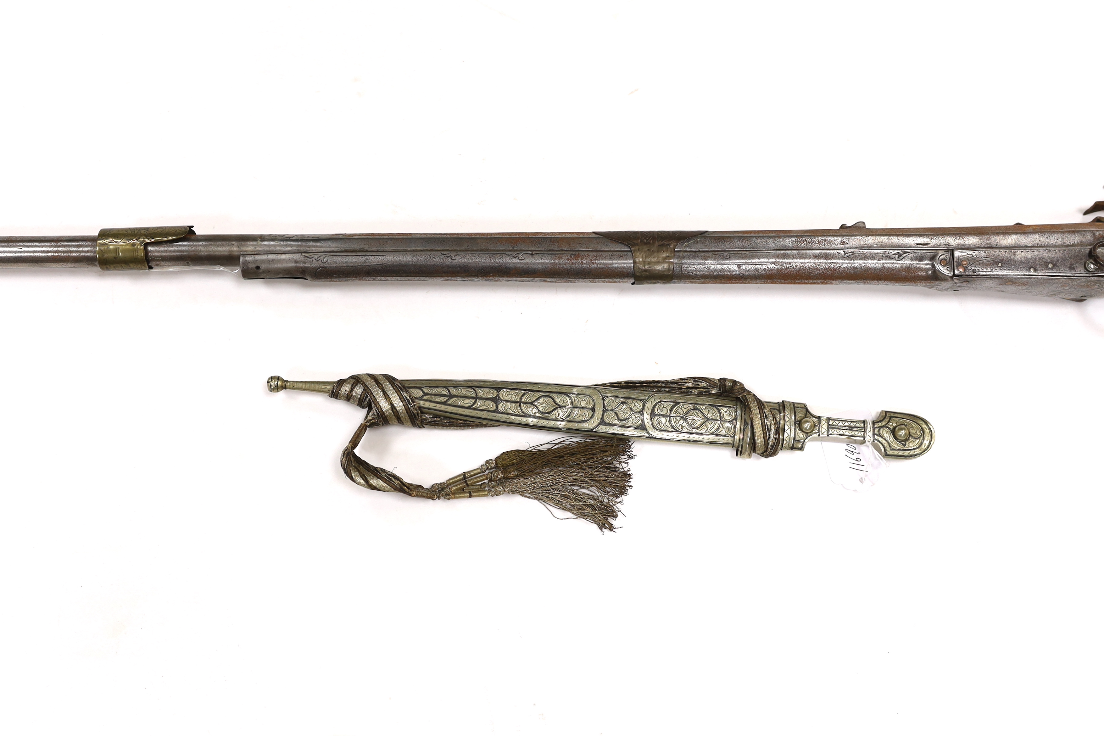 A 19th century Albanian flintlock miquelet lock rifle (Balkan long arm) and a Caucasian style dagger, with niello work scabbard, barrel 122cm (2)